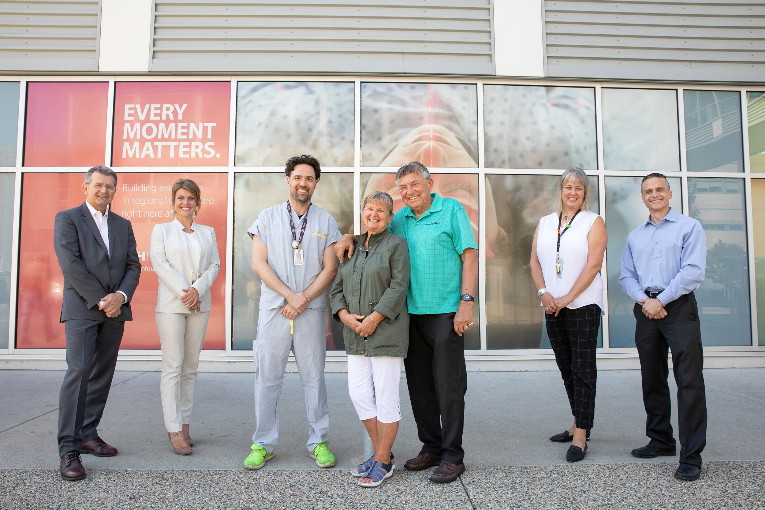 Doug Rankmore, KGH Foundation CEO; Allison Ramchuk, KGH Foundation Chief Development Officer; Dr. Nevin de Korompay, KGH Interventional Radiologist; Judy & Marshall Eliuk; Cory Bendall, IH Network Director, Stroke Care; Dr. Aleksander Tkach, KGH Vascular Neurologist, IH Stroke Network Medical Director standing outside of KGH.