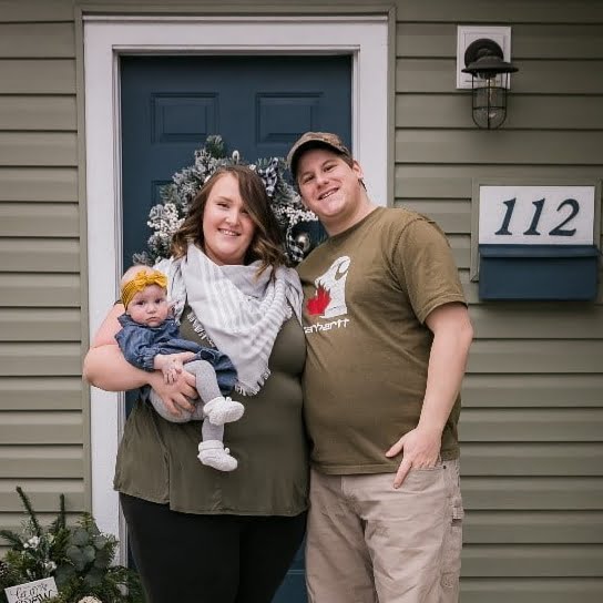 Man and woman holding their baby who was just released from the neonatal intensive care unit at Kelowna General Hospital