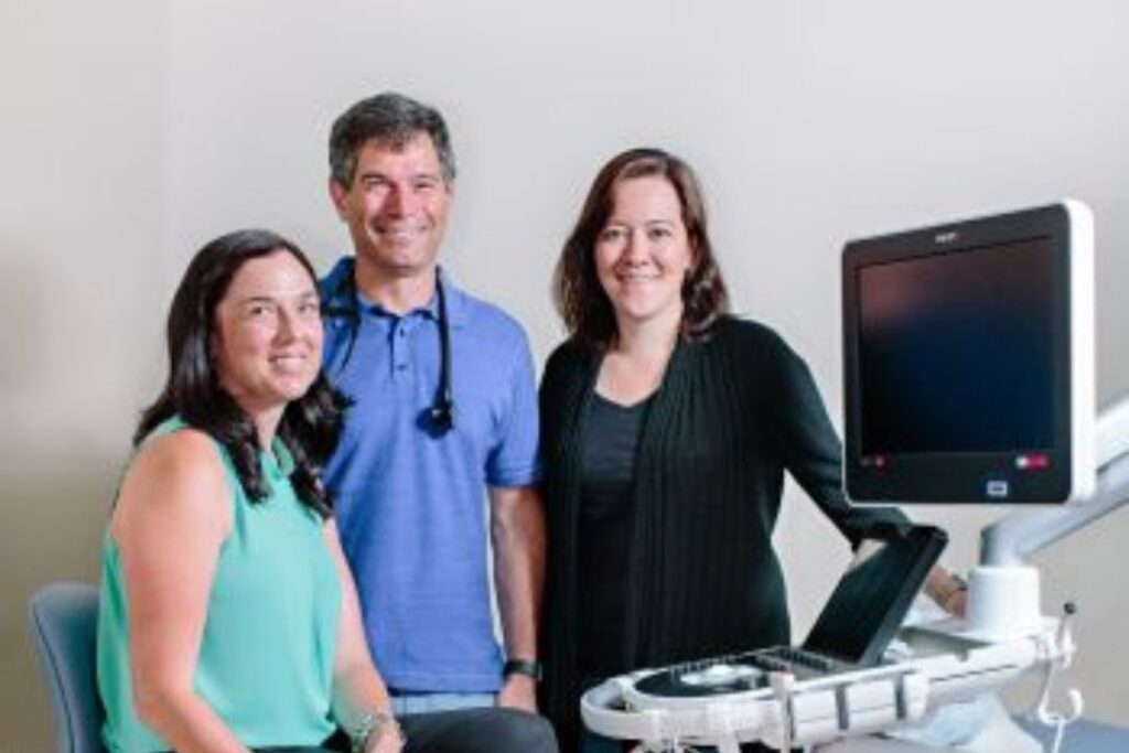 doctor and patients in front of medical equipment