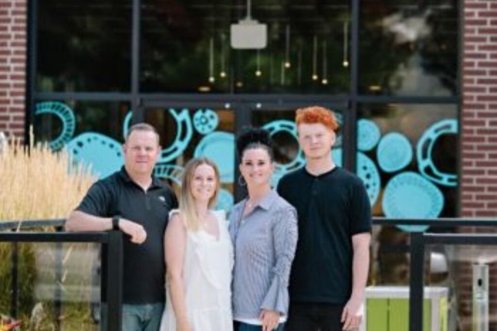 family outside of brick building